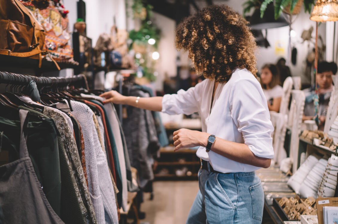 Shopper assessing clothing before estimating how often it will be worn